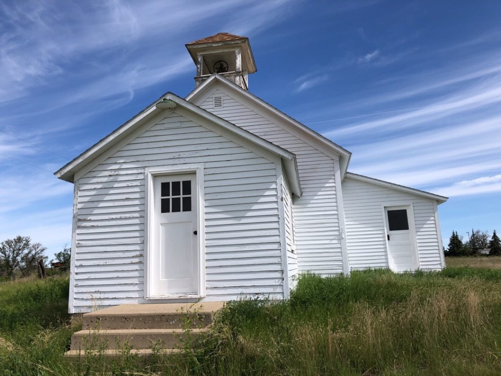 Painted siding on schoolhouses often fades more significantly on one side than on the others. This is due to weather exposure and is particularly common on the prairies of Montana.
